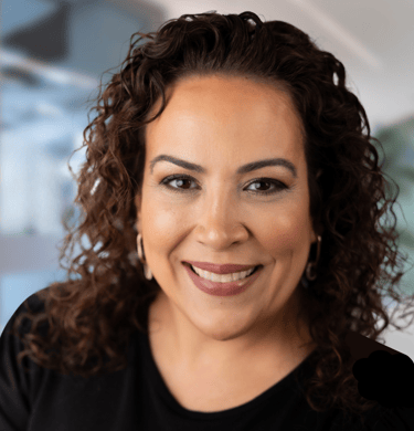 a woman with curly hair and a black shirt