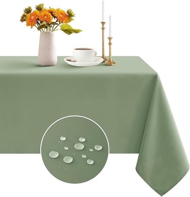 a table with a vase of flowers and a vase with a candle