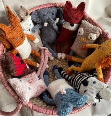 A basket of hand knitted soft toys