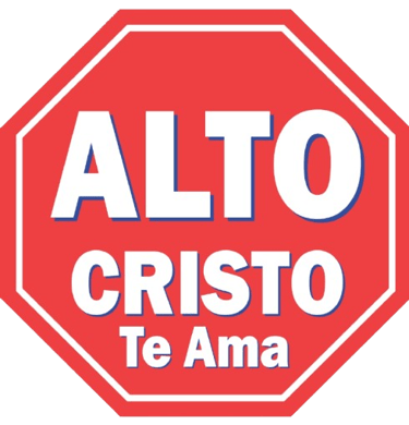 Red octagonal stop sign featuring the Spanish religious message Alto Cristo Te Ama.