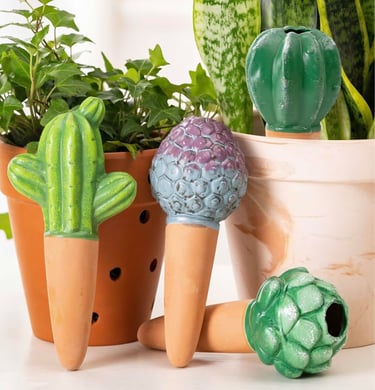 Decorative terracotta self-watering spikes shaped like cactus used as an automatic waterer