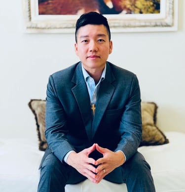 a man in a suit and tie sitting on a couch