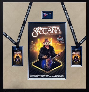 Framed Santana concert poster with VIP passes and guitar pin from the Greatest Hits Live show.