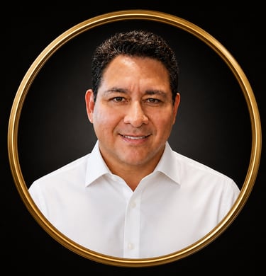 Professional headshot of a smiling man in a white dress shirt, framed by a circular gold border.