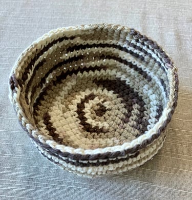 Brown, tan, cream colored crocheted coaster basket.