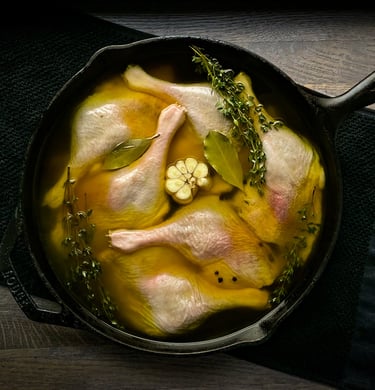 a pan of chicken with broth and vegetables in a skillet