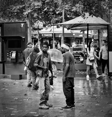 Two aboriginal men in a face-to-face discussion in the street photographed by Peter Pickering