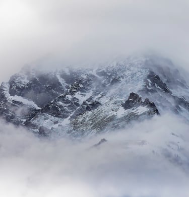A minimalist photo of a mountain during a snow storm.
