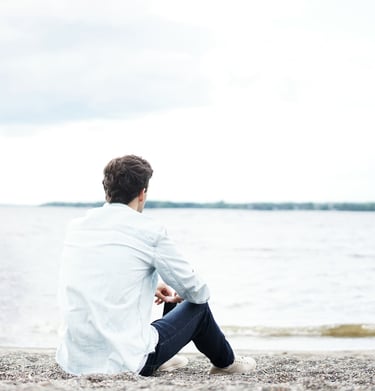 man sitting alone struggling with his challenges in life