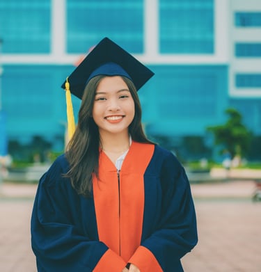 young woman dressed in graduation cap and gown heading into a life transition