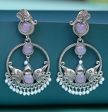 a pair of earrings with a purple and white flower