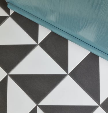 black and white geometric floor tile with a blue front door