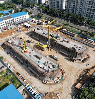 Time-lapse image of bustling large-scale construction site with cranes and modern machinery.