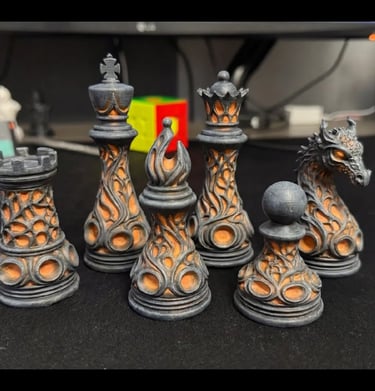 Custom 3D printed fantasy chess set featuring dragon and gothic flame designs in grey and orange.