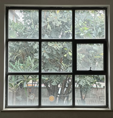 Before and after image of a residential home's front windows showing clear, streak-free glass.