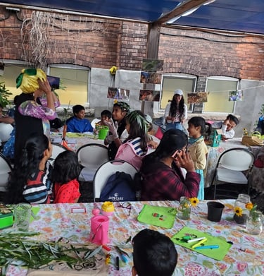 Children and families participate in an outdoor garden education workshop at a community urban farm.