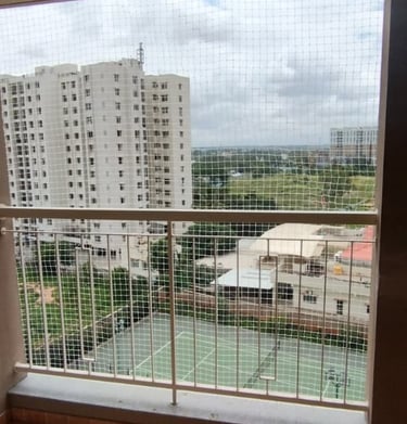 Child playing safely behind a balcony safety net installed by Arjilli Enterprises.