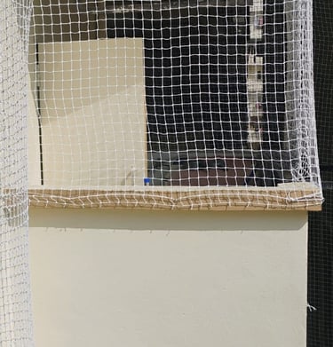Close-up of the net’s fine mesh texture designed to keep pigeons out.