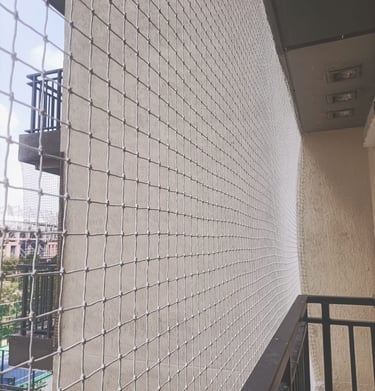 View of a balcony safety net protecting children playing safely indoors.