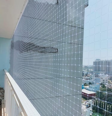 Wide shot showing a high-rise apartment balcony fully secured with a transparent safety net.
