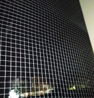 Close-up of the net’s fine mesh texture designed to keep pigeons out.