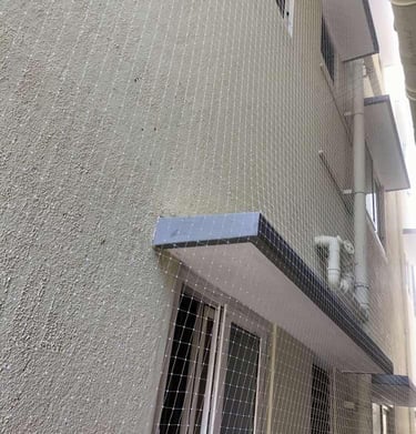 Close-up of mesh texture designed to keep pigeons out while allowing airflow.