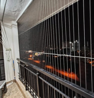 Evening photo capturing the subtle outline of invisible grills against a softly lit balcony.