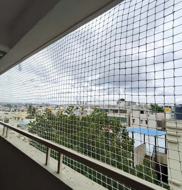 Wide shot showing a building facade covered with neatly installed anti-pigeon nets.