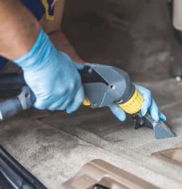 a man in blue gloves and gloves is using a cordless tool