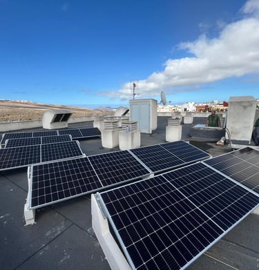 a man standing on a roof top with solar panels