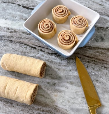 a knife and cinnamon rolls proofing