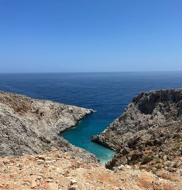 a person standing on a rocky cliff overlooking the ocean