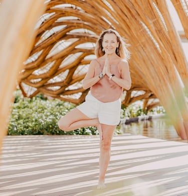 Erin B in a yoga pose at a retreat in Mexico