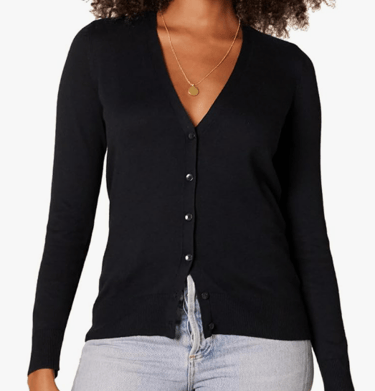 a woman wearing a black cardigan and light denim jean pants