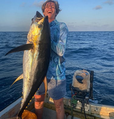 Fisherman holding a large Yellowfin Tuna during a Full-Day Fishing Charter in Zanzibar