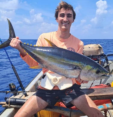 Happy client with a yellowfin tuna on a Zanzibar Catamaran Fishing Charter