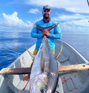 Angler proudly displaying a Yellowfin Tuna caught on a Full-Day Fishing Charter in Zanzibar