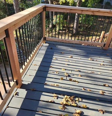 trex decking with cedar handrail and black balusters