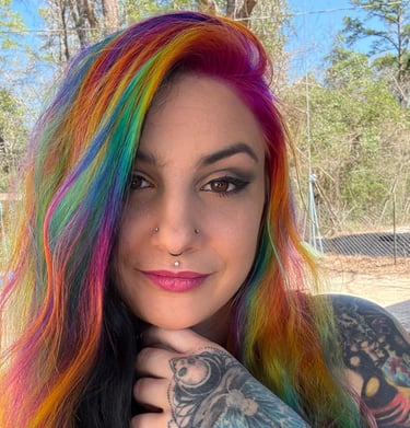 Tattoo artist in Pineville Louisiana that is trending on Tik Tok very talented with colorful hair