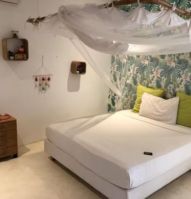 a bed with a canopy bed and a white bed