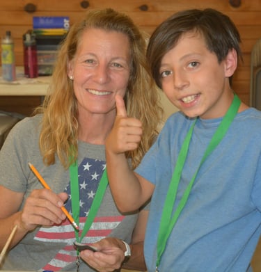a woman and a boy having fun at crafts