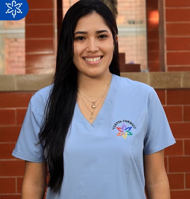a woman in scrubs and scrubs standing in front of a brick wall