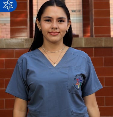 a woman in scrubs and scrubs standing in front of a brick wall