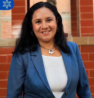 a woman in a blue jacket and white top