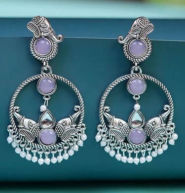 a pair of earrings with a purple and white flower
