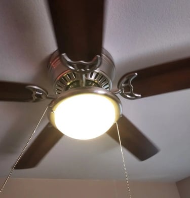 a ceiling fan with a light on top of it