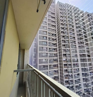 Elderly person enjoying fresh air on a balcony secured with a safety net, highlighting peace of mind