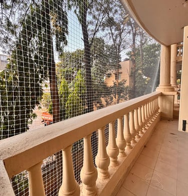Wide shot showing a freshly installed balcony net wrapping the entire railing securely.