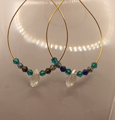 Elegant gold hoop earrings featuring iridescent blue and green beads with clear crystal pendants.
