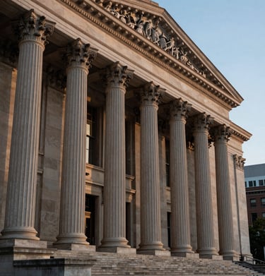 A high-contrast photo of classical architectural columns of a concert hall under evening sky lighting in a North American city.